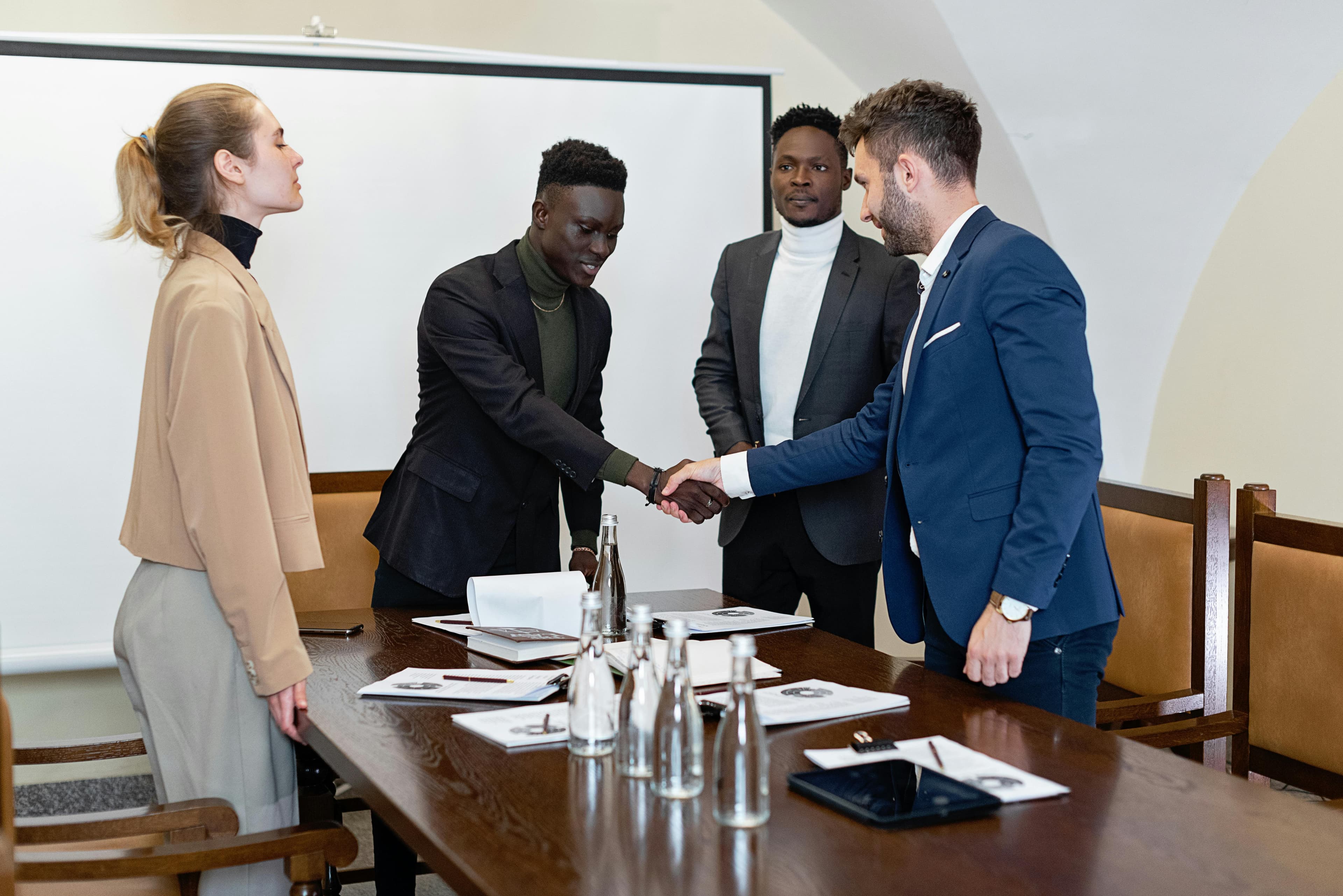 Executive partnership handshake in boardroom